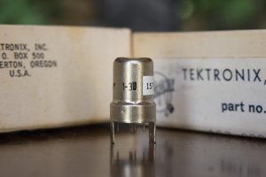 Nuvistor 7586 vacuum tube, boxes in background